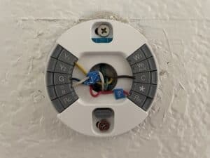 Google nest thermostat with the display removed to manually restart it